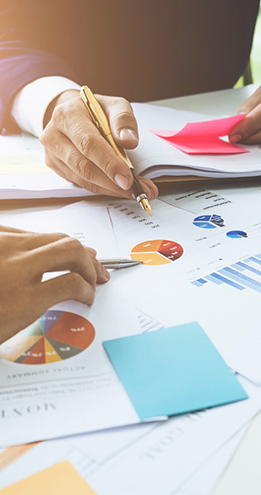 Global Payroll More Complex Than Ever Office workers pore over documents, symbolizing the complexity of global payroll.